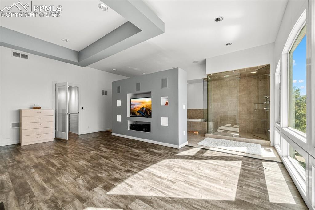Image 24 of 41: Full bathroom featuring a stall shower and dark wood finished floors