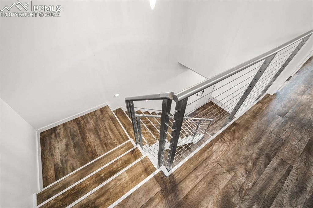 Image 29 of 41: Stairs featuring wood finished floors