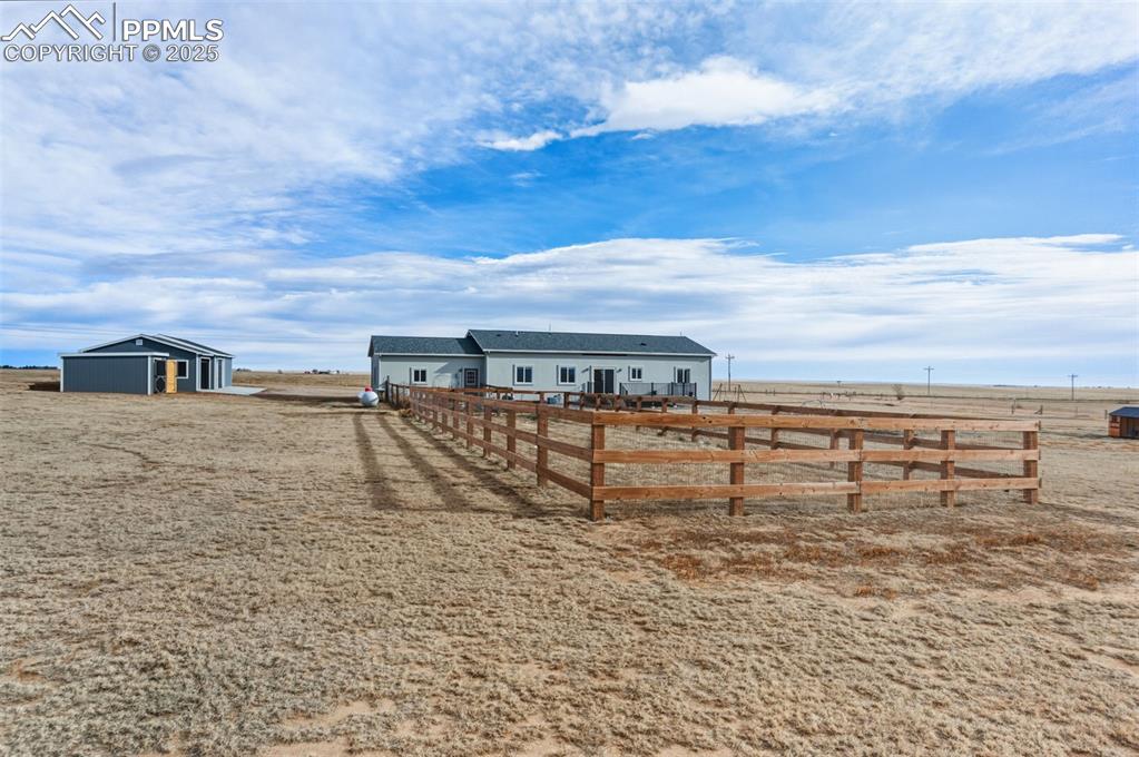 Image 42 of 50: View of yard featuring an outbuilding and a view of rural / pastoral area