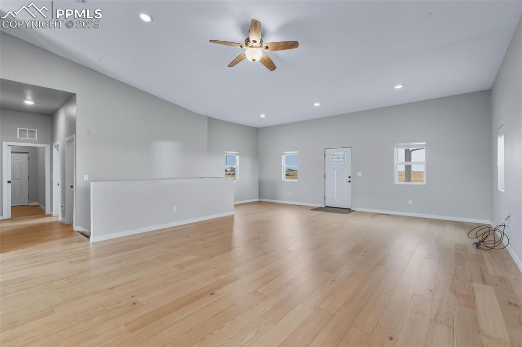 Image 7 of 50: Unfurnished living room featuring a ceiling fan, light wood-type flooring, 