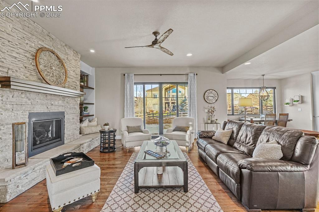 Image 10 of 46: Living area featuring ample natural light, gas fireplace and walk out to ba