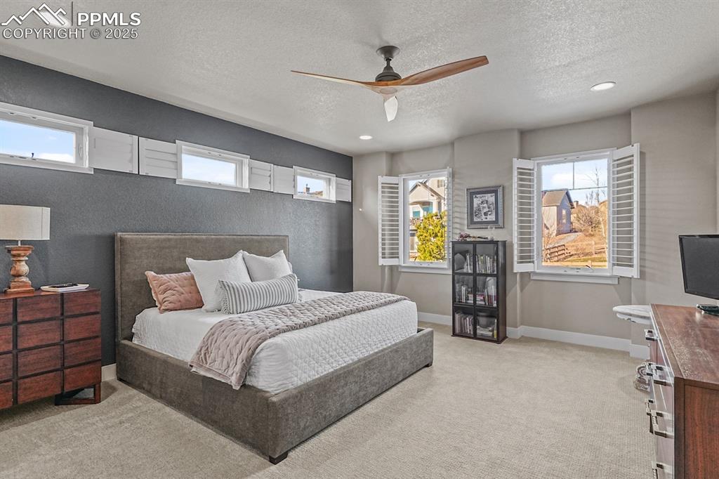 Image 16 of 46: Primary bedroom featuring high ceilings and ensuite bath