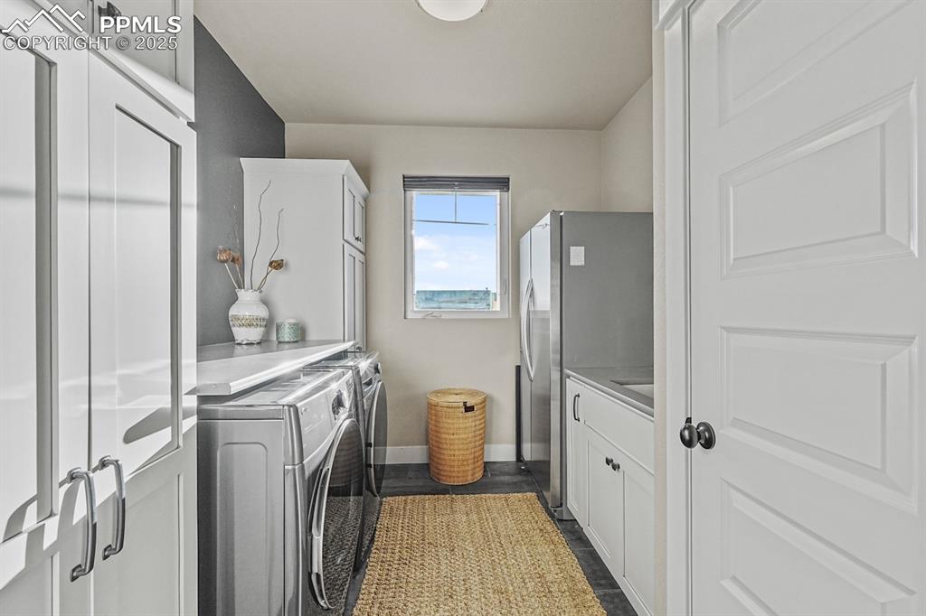 Image 21 of 46: Laundry room with ample cabinet space and storage 