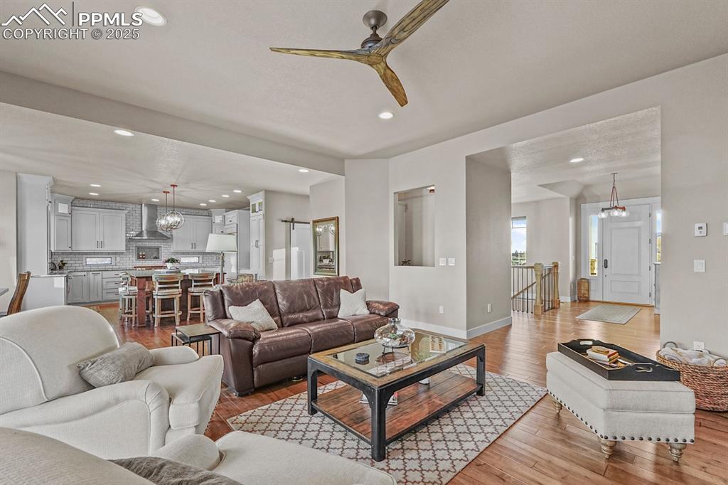 Image 9 of 46: Living area with wood flooring and recessed lighting