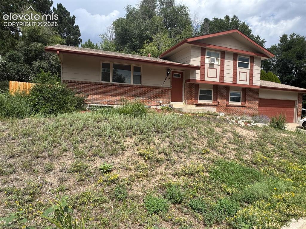 Caption: Split-level residence featuring brick and siding exterior