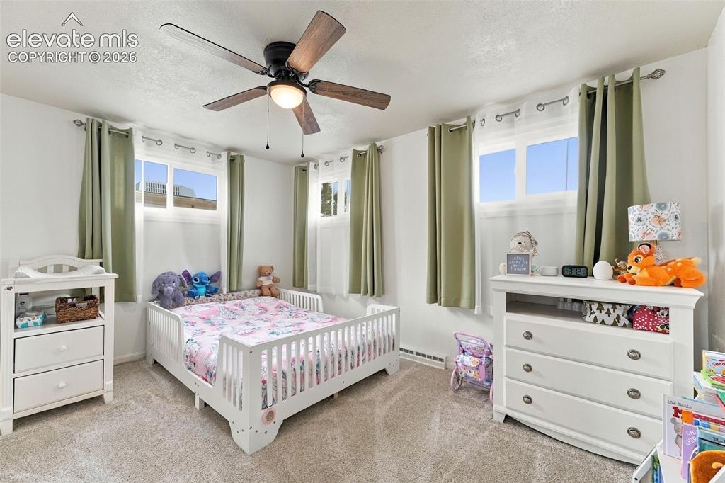 Image 11 of 48: Neutral-toned carpeting, white walls, and a ceiling fan with integrated lig