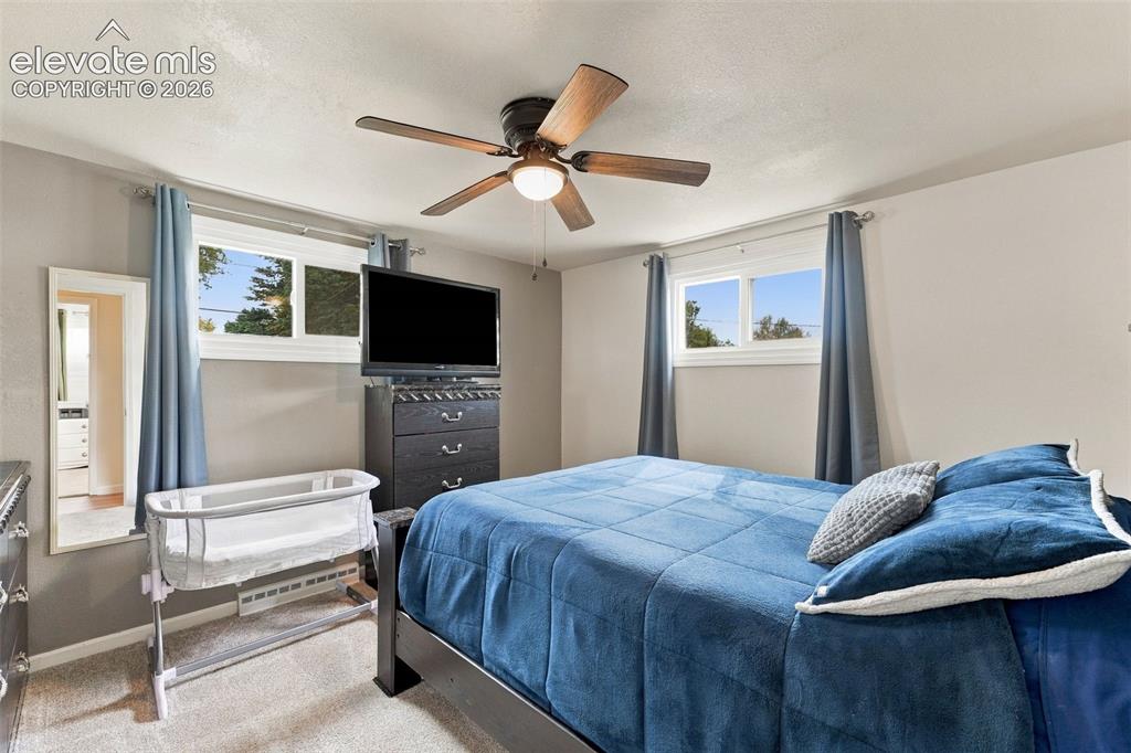Image 14 of 48: Recessed lighting, wood-finish ceiling fan, and carpeted flooring