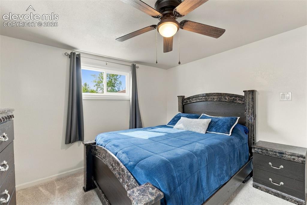Image 15 of 48: Carpeted flooring, window with natural light, ceiling fan with integrated l