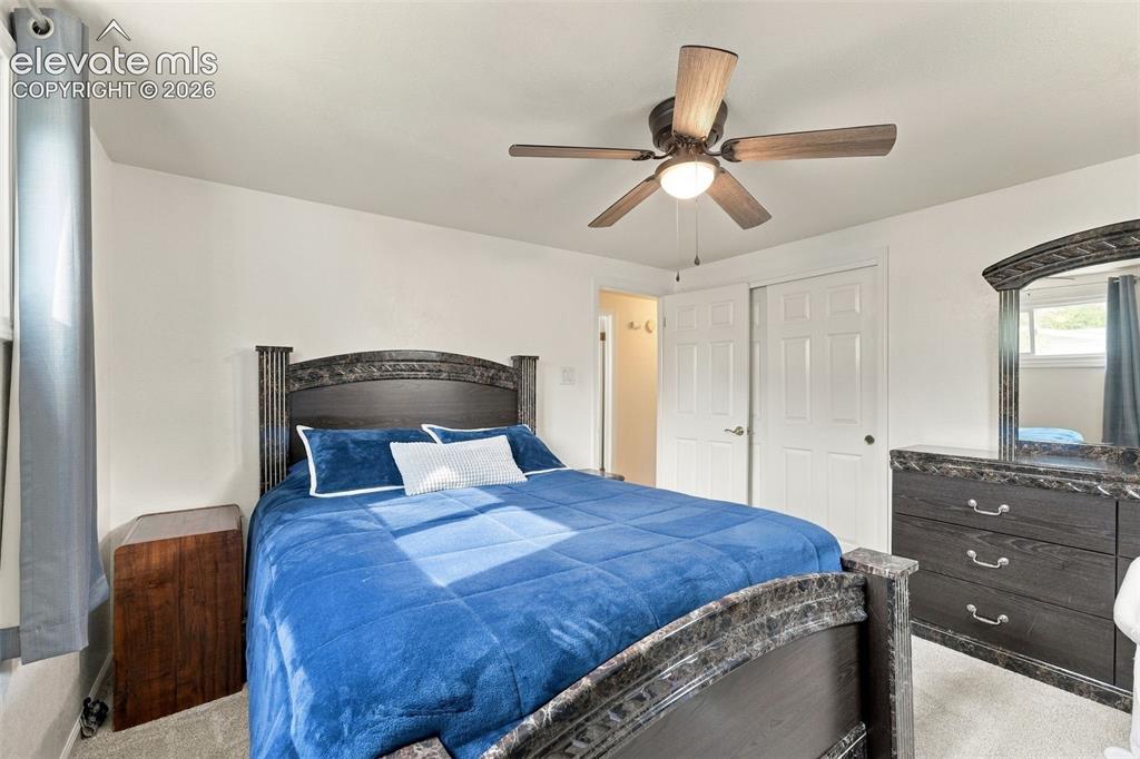 Image 16 of 48: Ceiling fan with integrated lighting, window with natural light, textured c