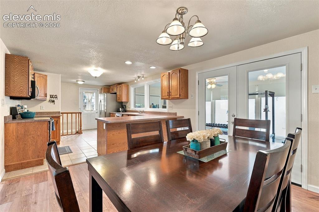 Image 19 of 48: Open-concept dining area with wood-finish flooring, recessed lighting, and