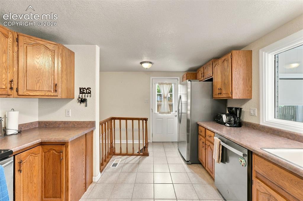 Image 21 of 48: Wood cabinetry and solid surface countertops