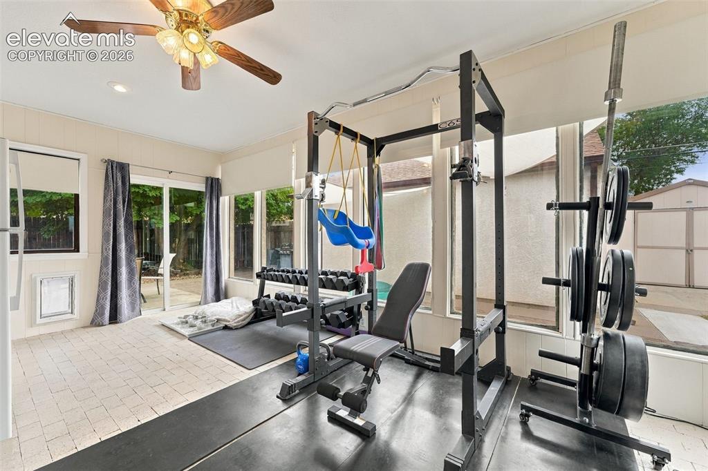 Image 25 of 48: Sunroom with light-toned tiled flooring, a ceiling fan, and recessed lighti