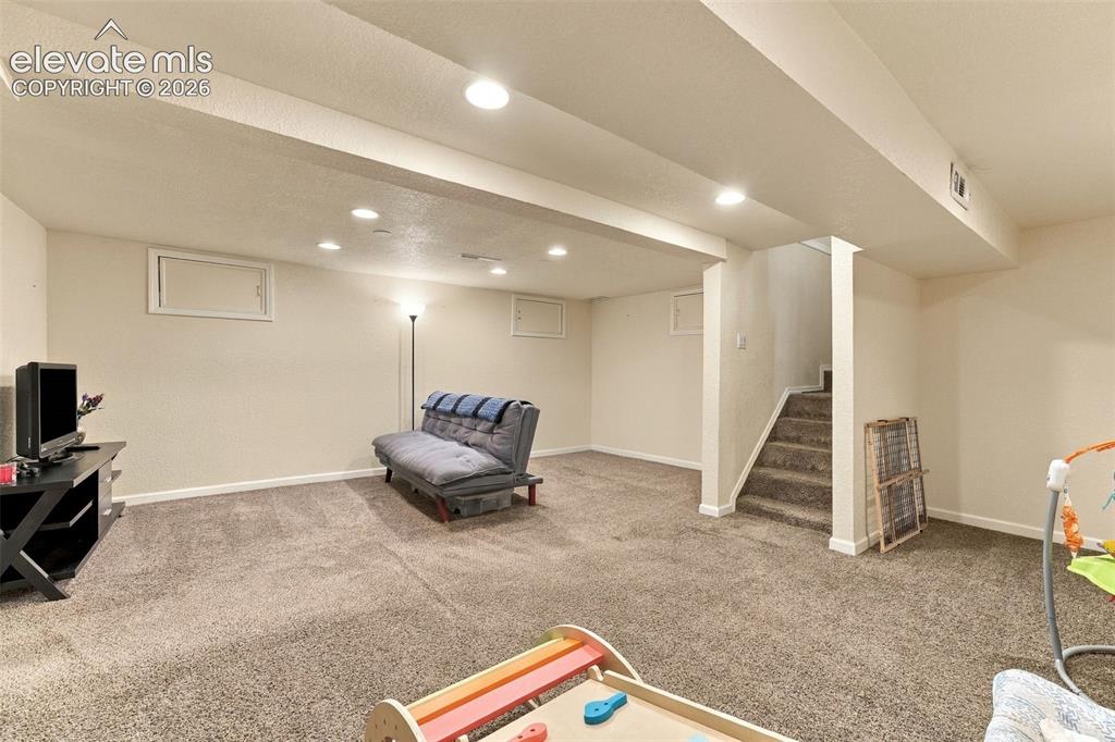 Image 31 of 48: Spacious room featuring neutral carpeting, recessed lighting, and access to