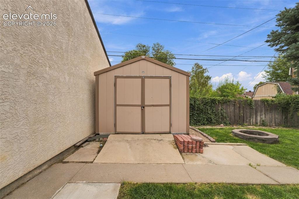 Image 45 of 48: Backyard featuring a detached storage shed, concrete patio, and a built-in 