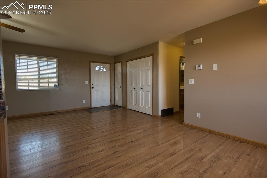 Image 11 of 27: Front door entry into the living room
