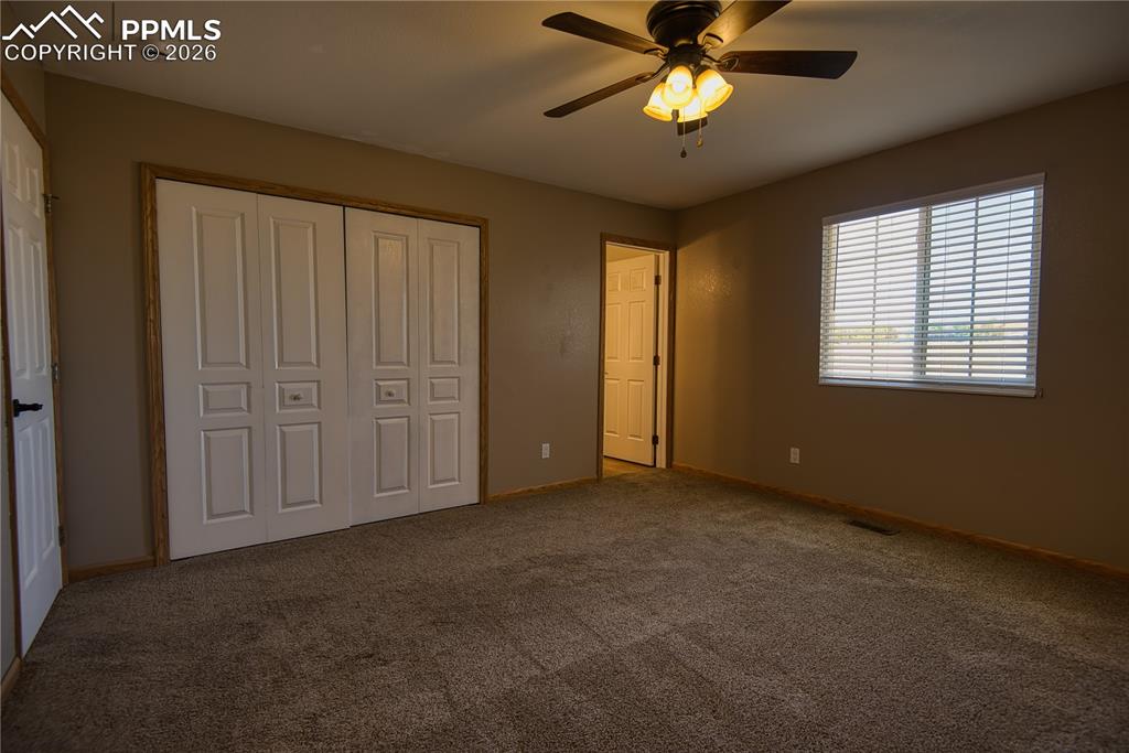 Image 14 of 27: Closet and entry to bathroom 
