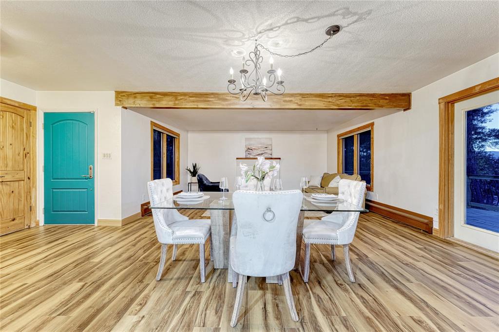 Image 10 of 49: Spacious dining room with walk out to large deck with Pikes Peak views
