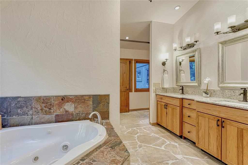 Image 17 of 49: Primary bath with jacuzzi tub