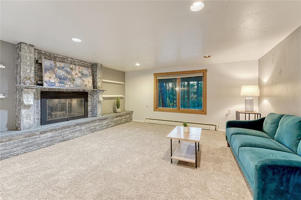 Image 23 of 49: 2nd family room in basement with fireplace