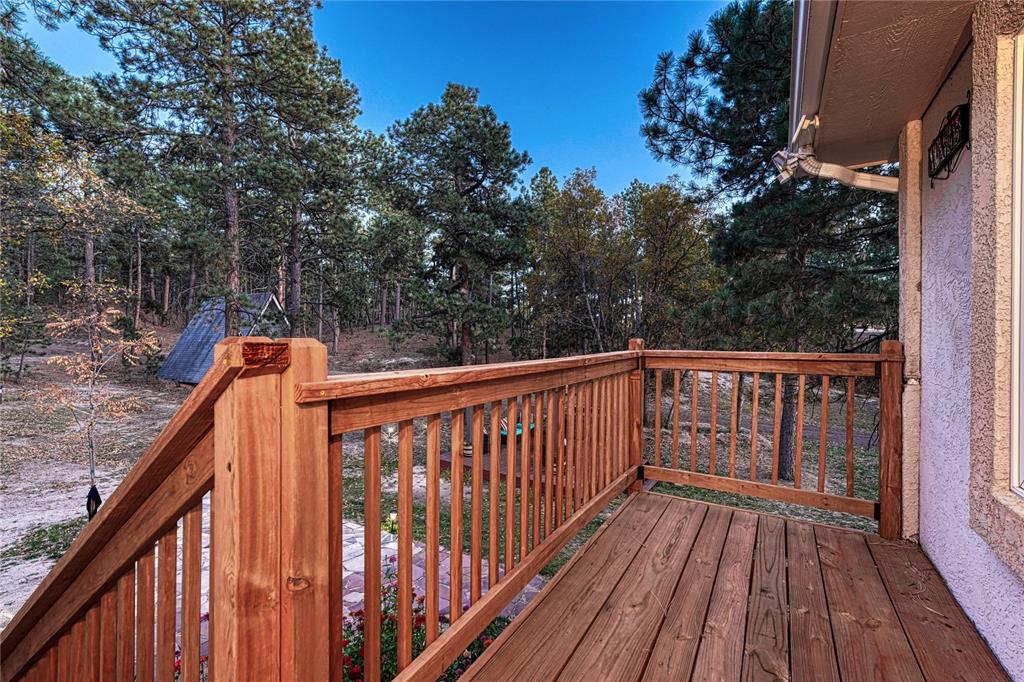 Image 30 of 49: Deck off back door leading to outdoor entertainment area