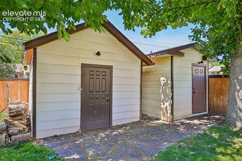 Image 5 of 41: Two large storage sheds in backyard