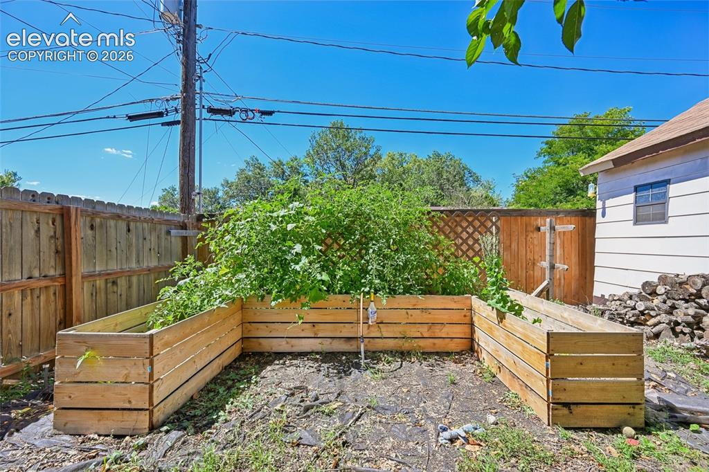 Image 8 of 41: Raised beds in backyard for garden