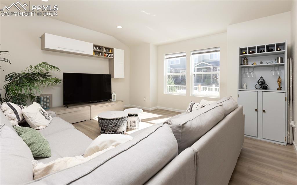 Image 19 of 34: Living area opens to kitchen and dining