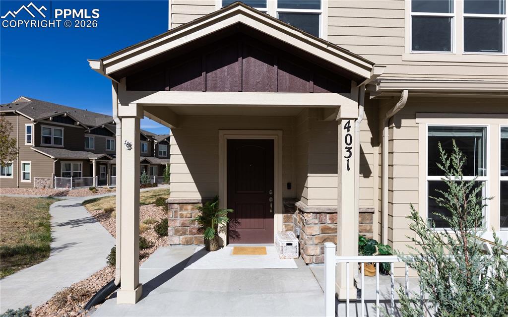 Image 2 of 34: Inviting front porch faces the courtyard