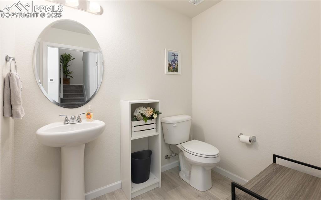 Image 7 of 34: First floor powder room just in from the garage