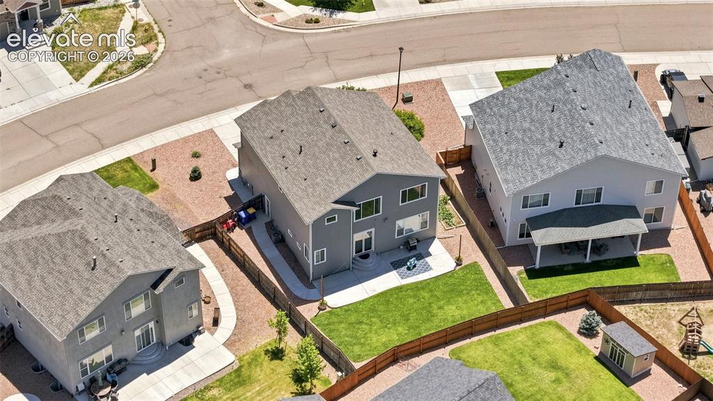 Image 44 of 50: Two-story residence featuring a gray exterior and a shingled roof