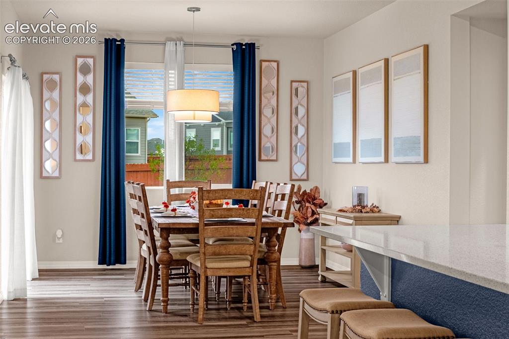 Image 14 of 40: Wood-finish flooring, recessed lighting, double-paned window, drum pendant