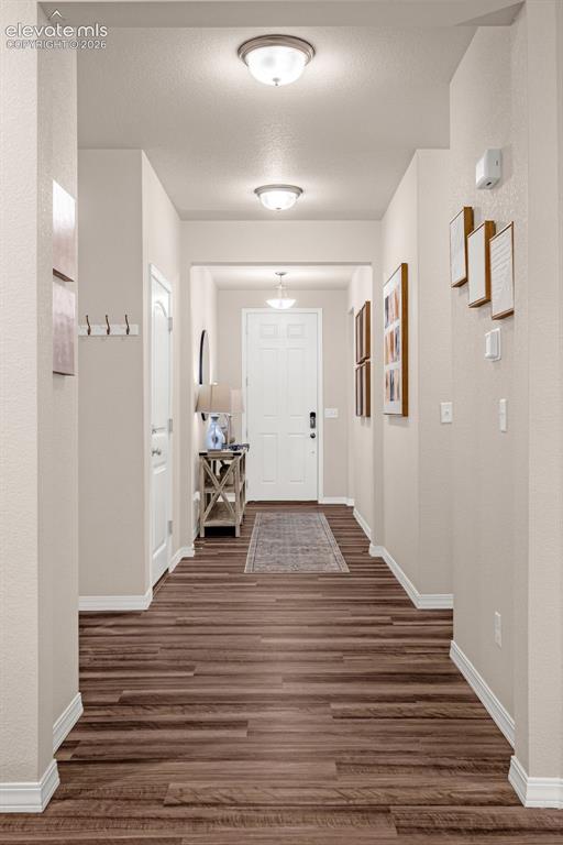 Image 15 of 40: Hallway with wood-finish flooring, light neutral paint, and recessed lighti