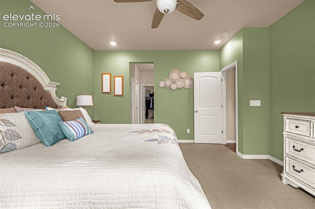 Image 15 of 40: Recessed lighting, ceiling fan, and painted interior walls