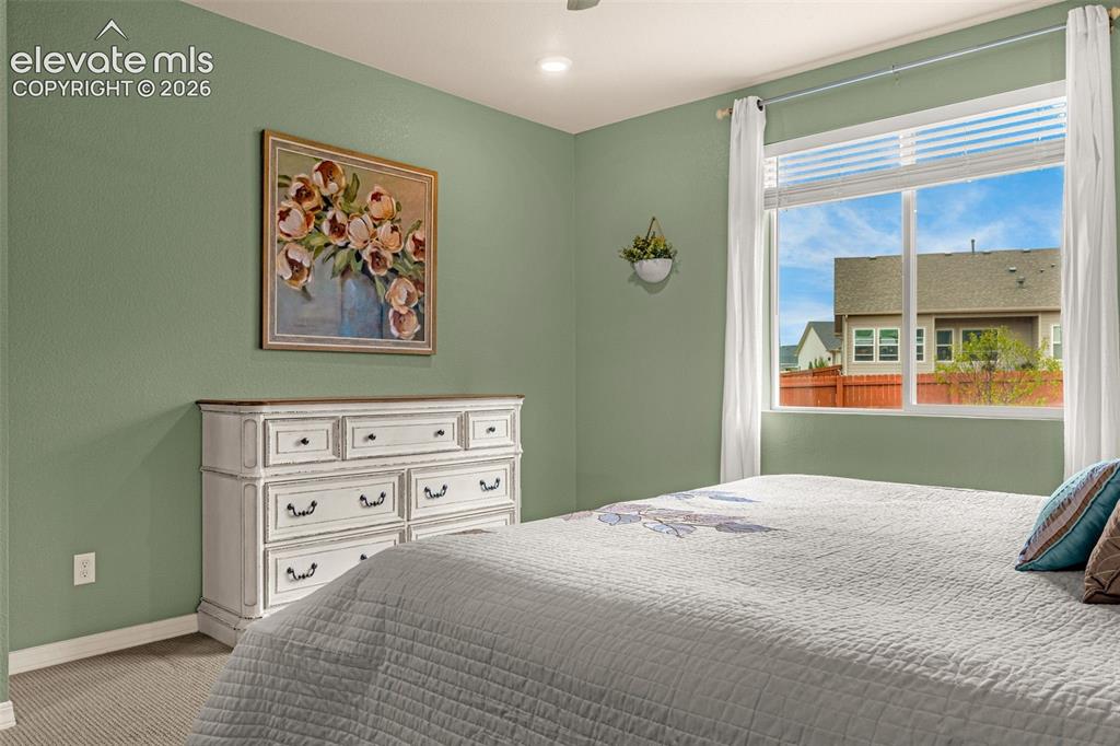 Image 19 of 40: Recessed ceiling lighting, large window with blinds, carpeted flooring, and