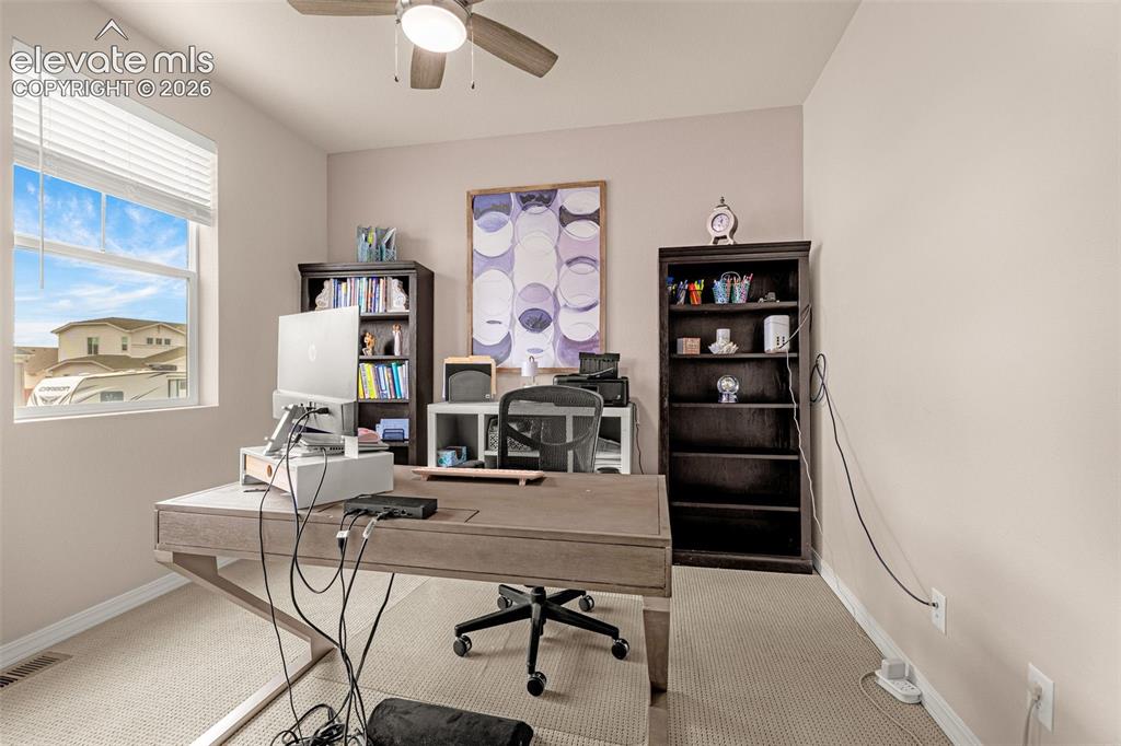 Image 24 of 40: Neutral wall paint, window with blinds, ceiling fan with integrated lightin