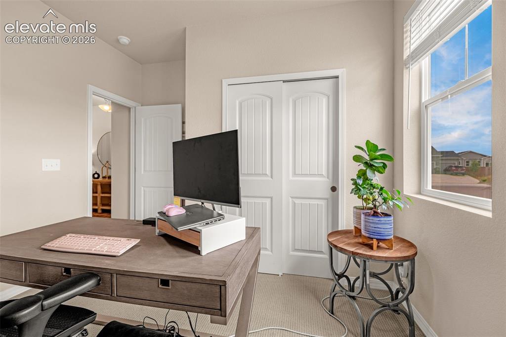 Image 25 of 40: Recessed lighting, light-toned wall paint, a single window with blinds, and