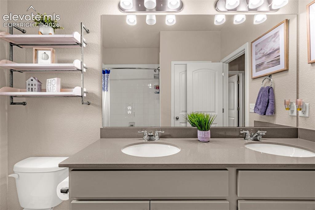 Image 27 of 40: Dual vanity with undermount sinks and chrome fixtures