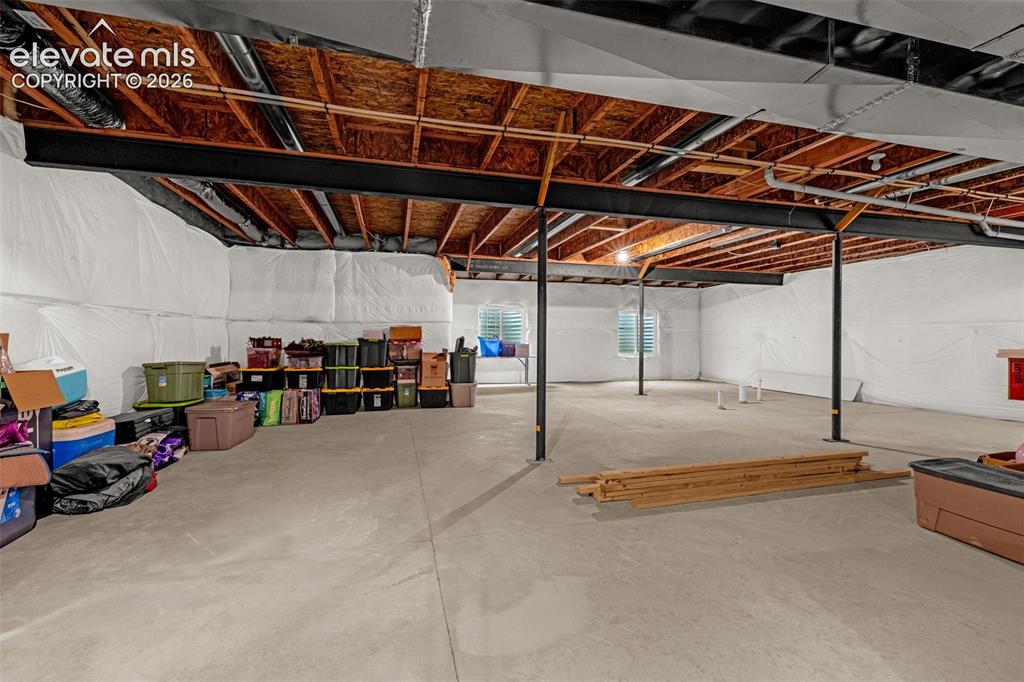 Image 29 of 40: Expansive unfinished basement featuring concrete flooring, exposed ceiling 