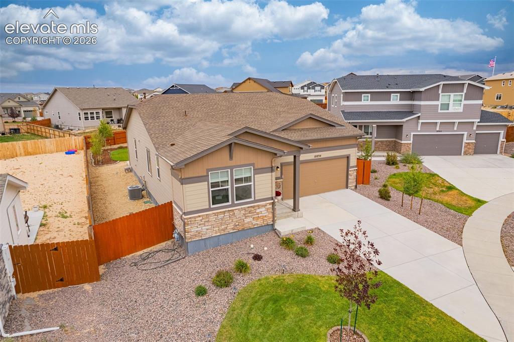 Image 35 of 40: Single-story residence featuring a two-car garage, stone and siding exterio