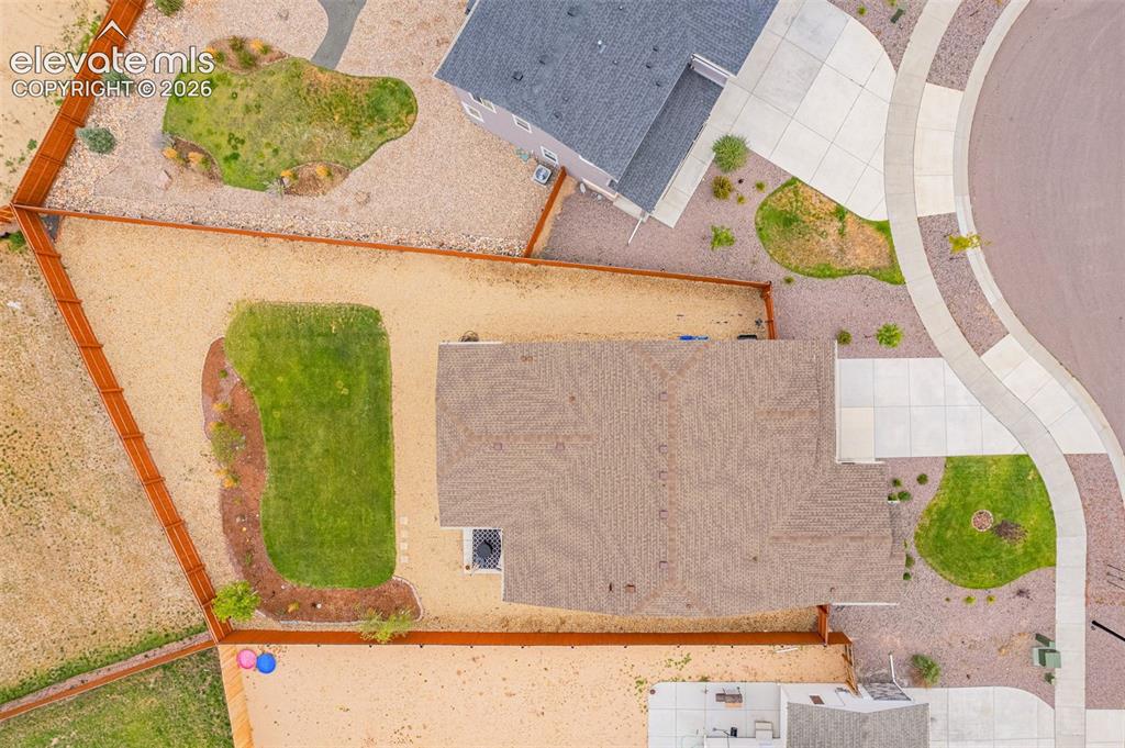 Image 36 of 40: Expansive property with a shingled roof, defined perimeter fencing, and a m