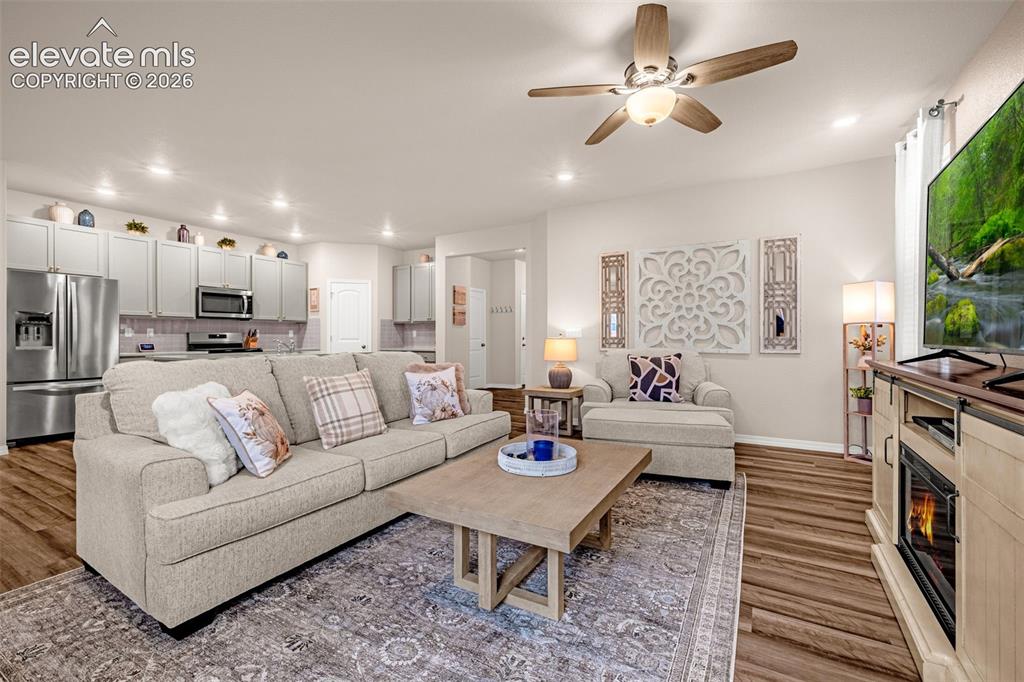 Image 7 of 40: Recessed lighting, wood-finish flooring, ceiling fan with integrated lighti