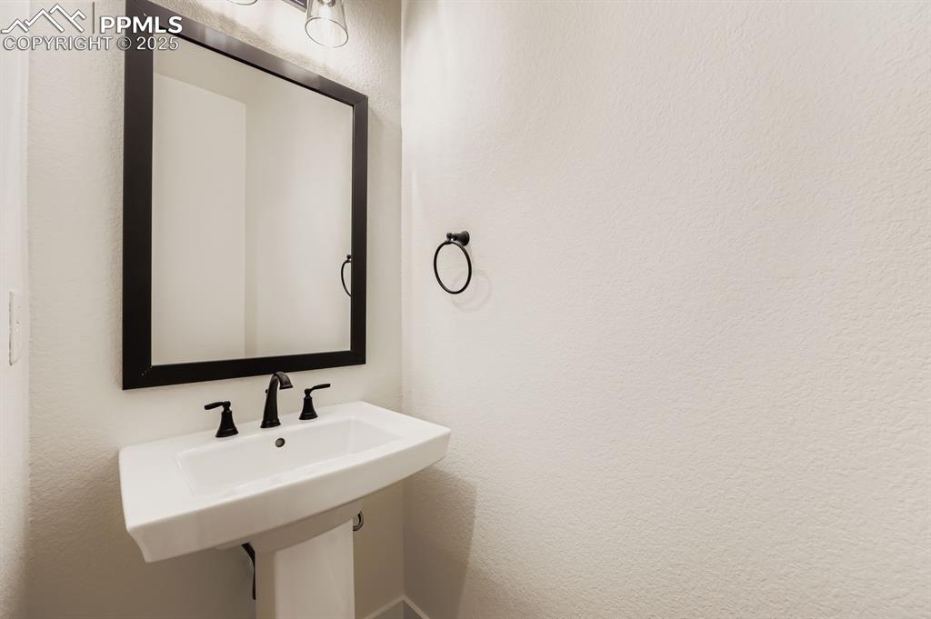 Image 13 of 29: Bathroom with a textured wall and a sink