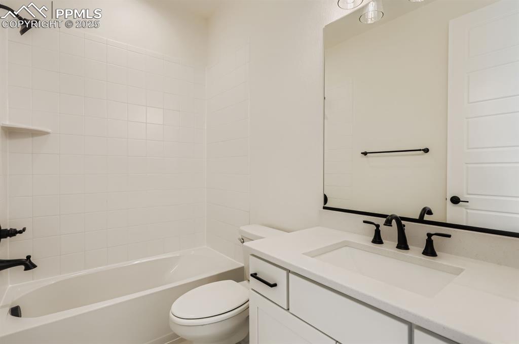 Image 20 of 29: Bathroom with vanity and shower / washtub combination