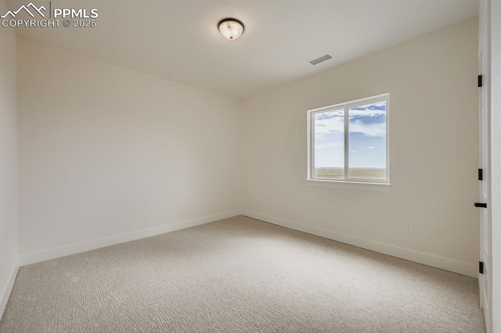 Image 23 of 29: Unfurnished room featuring carpet flooring and baseboards