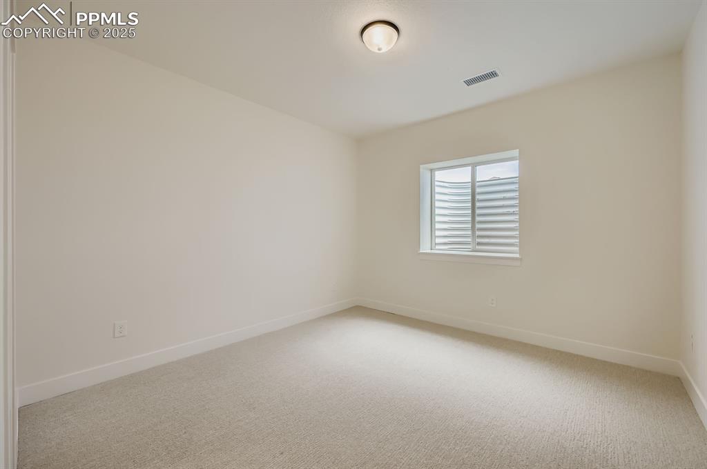 Image 25 of 29: Unfurnished room featuring light carpet and baseboards