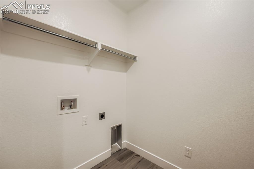 Image 26 of 29: Laundry room featuring washer hookup, hookup for an electric dryer, and dar