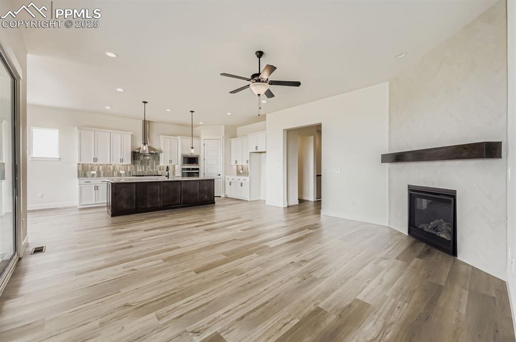 Image 6 of 29: Unfurnished living room featuring light wood finished floors, recessed ligh