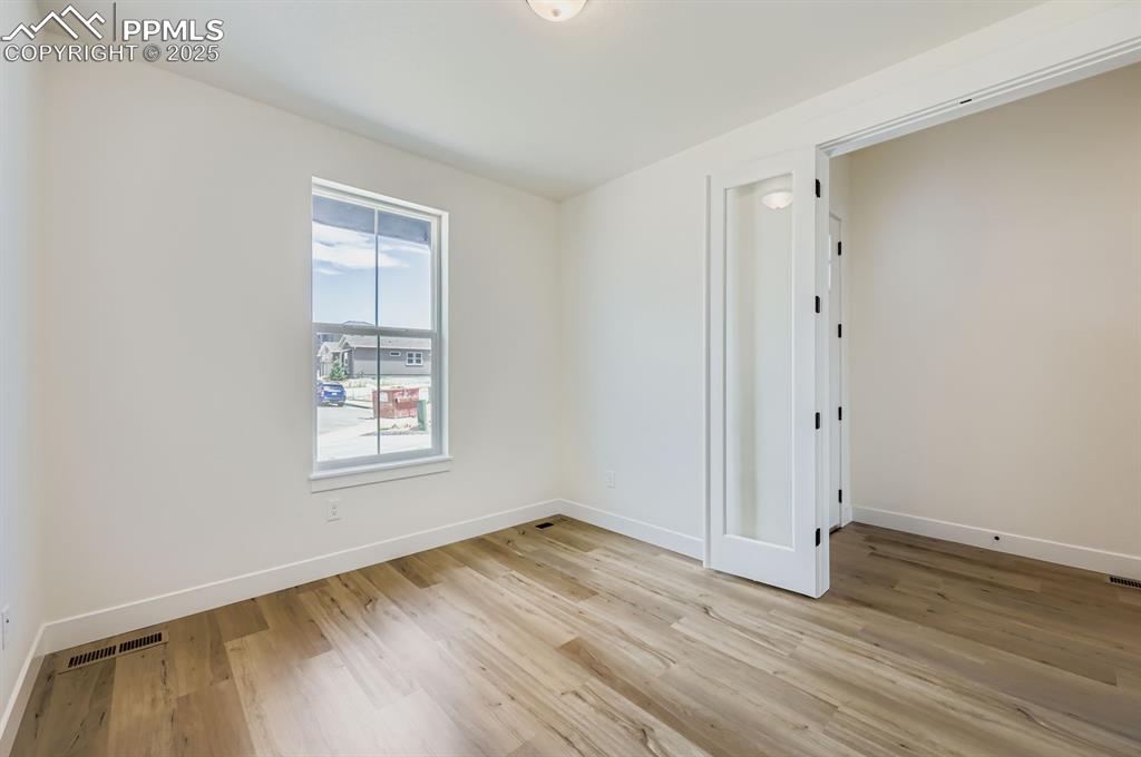 Image 8 of 29: Spare room featuring light wood-style flooring and baseboards