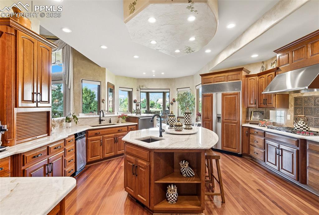 Image 20 of 50: Taj Mahal countertops with hand carved edging on the island. The custom laz
