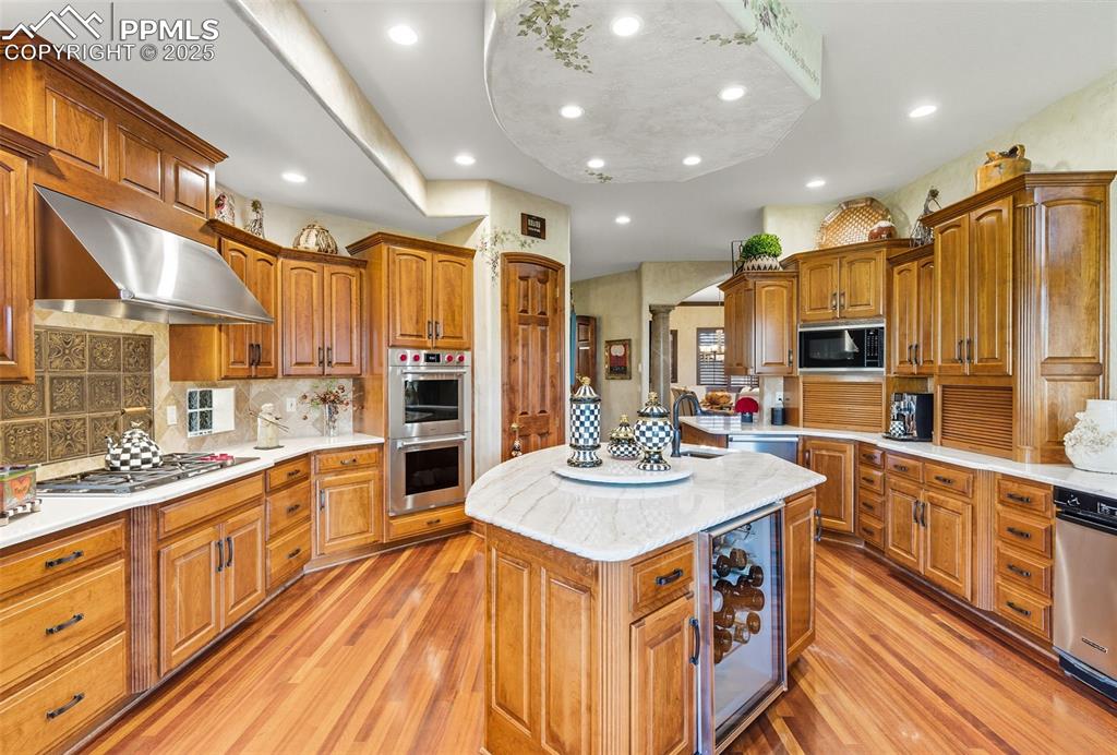 Image 22 of 50: Wolf double ovens, Subzero refrigerator, 2 Meile dishwashers, wine cooler a